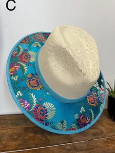 Medium Size Our hats are stylish and is completely unique in design, perfect to add that special touch to any outfit. Embroidered Summer Hat With Short Brim, Summer Embroidered Short Brim Hat, Summer Brimmed Hats With Embroidery, Blue Embroidered Curved Brim Hats, Embroidered Wide Brim Summer Hat, Summer Embroidered Wide Brim Hat, Summer Wide Brim Embroidered Hats, Embroidered Flat Brim Summer Hat, Adjustable Embroidered Straw Hat With Curved Brim