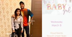 a man and woman standing next to each other in front of a baby girl sign