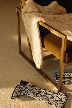 a pair of black and white patterned socks sitting on the floor next to a chair