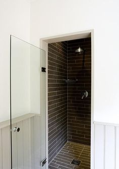 a walk in shower sitting inside of a bathroom