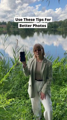 a woman taking a selfie in front of a lake with the text use these tips for better photos