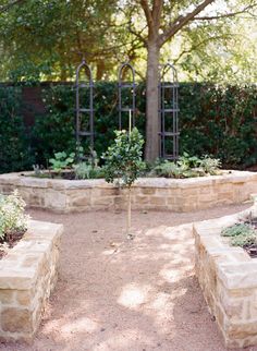 an outdoor garden with stone benches and trees