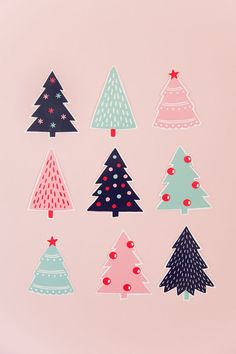 christmas tree stickers on pink background with red and blue decorations in the shape of trees