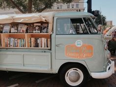 an old blue truck with books on the back