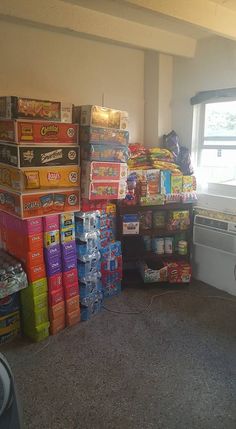 a room filled with lots of boxes and containers on the floor next to a window