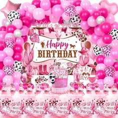 a pink birthday party with balloons and decorations