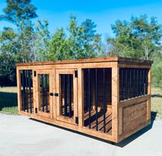 a dog kennel made out of wood with bars on the sides and doors open