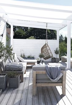 an outdoor patio with furniture and potted plants on the deck, as seen on instagram