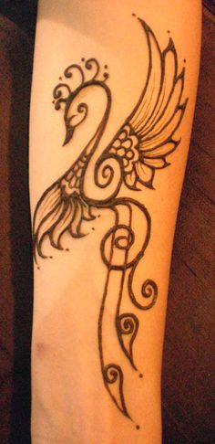 a woman's arm with a tattoo design on the side of her leg and an intricate