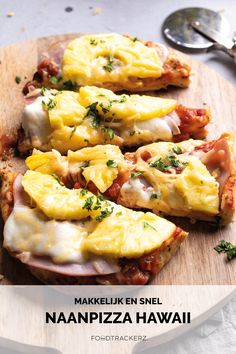 three slices of pizza with cheese and ham on them sitting on a wooden cutting board