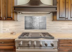 a stove top oven sitting inside of a kitchen next to wooden cabinets and counter tops