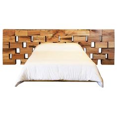 a bed made out of wooden blocks with white sheets and pillows on the headboard