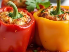 three stuffed peppers on a plate with parsley