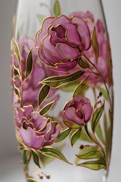 a wine glass with pink flowers painted on it