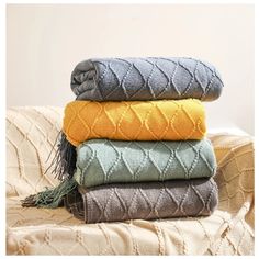 four blankets stacked on top of each other