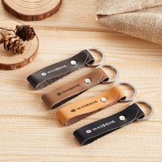 three leather keychains with the word'happiness'engraved on them