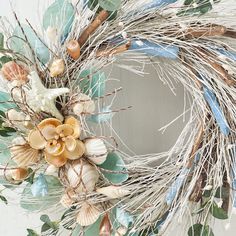 a wreath decorated with seashells and seaweed