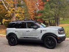 an suv parked in front of some trees