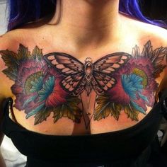 a woman's chest with a butterfly tattoo on it