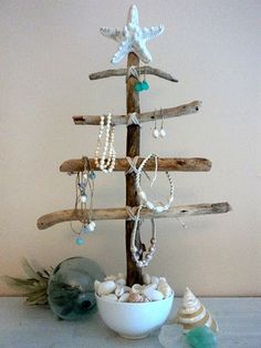 a christmas tree made out of driftwood and seashells