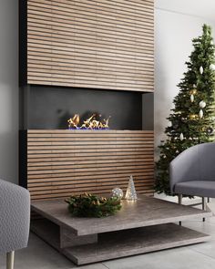 a living room with a christmas tree in the corner and a fireplace on the wall