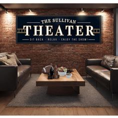 a room with two couches and a coffee table in front of a brick wall