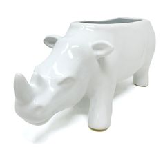 a white ceramic rhino planter on a white background