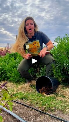 a woman is kneeling down in the grass