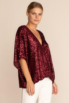 One of our most flattering silhouettes, the Concourse top is back in glittering ruby-colored sequins. Featuring a low surplice neckline and fluttery, dolman sleeves, this sparkling top is perfect for a holiday get-together at home or away. Surplice neckline Dolman sleeves Model in Garnet Red 5'10", wearing size M Model in Emerald Green is 5'10", wearing size S All That Glitters Sequins Dry Clean Only Imported Red Sequin Top, Sparkly Top, Garnet Red, Surplice Neckline, Red Sequin, All That Glitters, Sequin Top, Trina Turk, Red Garnet