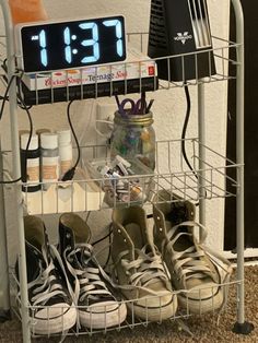 two pairs of shoes are sitting under a digital clock