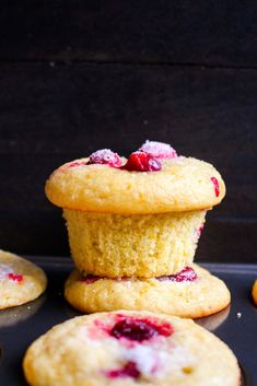 three raspberry muffins stacked on top of each other