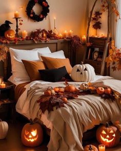 a bedroom decorated for halloween with pumpkins and candles