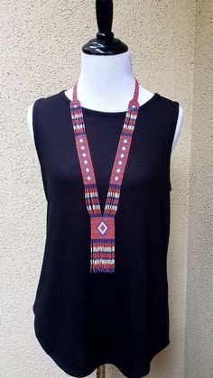 Colorful long shiny Native American seed bead necklace with fun fringe in a striking pattern. This necklace says summer, beach, resort. Necklace measures 16 inches, pendant measures 4 1/2 inches from top to the bottom of the fringe. No clasp, just slip over your head. Striking with a swingy beach dress or a jean jacket. Shop more necklaces here: https://www.etsy.com/shop/BoutiqueByMaryam?section_id=21694658 Be sure to visit the rest of my shop here: https://www.etsy.com/shop/boutiquebymaryam Bohemian Beaded Dangle Tassel Necklace, Bohemian Tassel Necklace With Beaded Chain, Bohemian Lariat Necklace With Tassels, Bohemian Lariat Necklace With Tassels For Gifts, Artisan Lariat Necklace For Festivals, Bohemian Fringe Lariat Necklace, Bohemian Lariat Necklace With Tassels As Gift, Bohemian Lariat Necklace With Fringe, Southwestern Beaded Lariat Necklace