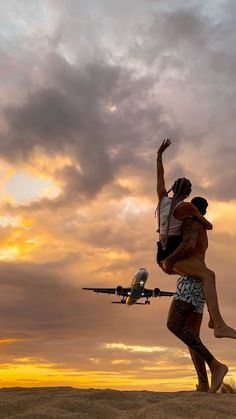 a man carrying a woman on his back as an airplane flies in the sky behind him