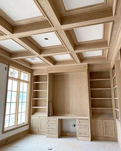 an empty room with built - in shelves and wooden ceilinging is seen here,