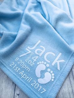 a baby blue blanket with the name jack on it and an image of a foot print