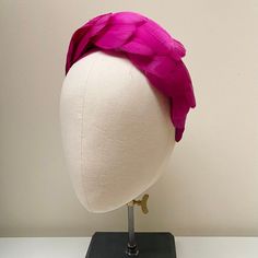 "FABRIC This Women's fascinator headband is carefully hand made. The headband has been covered in a complementary crepe fabric and each feather has been attached within the seams of the fabric headband for a flawless finish. The head crown is light, soft and super comfortable and boasts a quality finish. FIT and SIZE A flexible base band to fit all head sizes.  PACKAGING Each headband is wrapped in pretty acid free tissue paper, sealed with an Evierosemade brand sticker and shipped in an eco-friendly cardboard gift box to protect while in transit. If you are purchasing as a gift, please select \"This order is a gift\" (the item price will not be included in the gift box). If you would also like to add a personalised message to the recipient, please enter your message in the box marked \"Ad Pink Structured Crown Fascinator For Wedding, Pink Structured Crown Headpiece For Party, Pink Structured Crown Headpiece For Wedding, Pink Headband Fascinator For Evening, Pink Evening Fascinator Headband, Pink Structured Crown Headpiece For Races, Pink Pinched Crown Headpiece For Races, Pink Headband For Royal Ascot, Pink Headband For Races