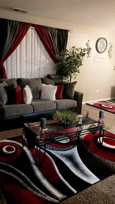 a living room filled with furniture and a red rug on top of a carpeted floor