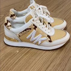 Authentic Michael Kors Sneakers Sz 7. Brand New Without Tag Or Box. Luxury White Sneakers With Removable Insole, Michael Kors Chunky Sneakers, Designer Gold Lace-up Sneakers, Michael Kors Low-top Casual Sneakers, Michael Kors Sneakers With Textured Sole, Sporty Michael Kors Synthetic Sneakers, Gold Leather Slip-on Sneakers, Michael Kors High-top Synthetic Sneakers, Michael Kors Sneakers