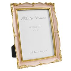 a pink and gold frame sitting on top of a table