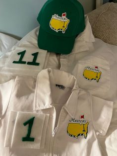 several shirts and hats are laid out on top of each other, including one with the number 11