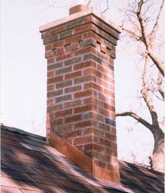 a brick chimney on top of a roof