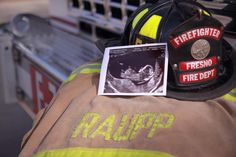 a firefighter's helmet and photos are on the back of a fire truck