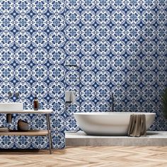 a bath tub sitting next to a white sink in a bathroom under a blue tiled wall