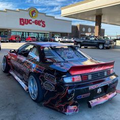 a car parked in front of a buc - ee's store with its hood up