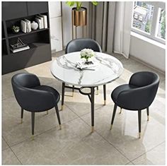 a white marble table with four chairs around it