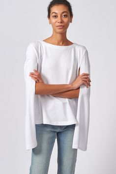 Our Cape Sweatshirt in our Bamboo and Cotton French Terry is the perfect combination of casual and chic. With enough attitude to turn heads, this style pairs well with your favorite jeans or slim trousers.DUE TO POPULAR DEMAND, THIS STYLE WILL REPLENISH MAY 21ST Boatneck shape with facing, cape back detail with longer length, wide hem finish. - 67% Bamboo Rayon, 28% Cotton, 5% Elastin - Made in NYC - Dry Clean or Machine Wash - Our model is 5'9" wearing size S - Chest: 30", Bottom Width: 40, Len Elegant Cape Top For Spring, Elegant Spring Cape Top, Casual Cape-style Top, Oversized Casual Cape Top, Oversized Cape Top In Casual Style, Spring Casual Cape Tops, Casual Cape Tops For Spring, Spring Trousers, Spring Sweatshirt