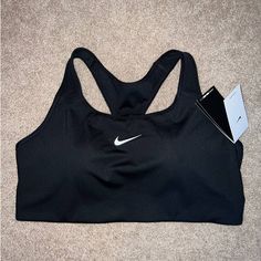 Nike Dri-Fit Sports Bra, New With Tags Still Attached, Medium Impact Support, Has Removable Padding, Racerback Style, Training Level Of Activity Per Tag, Color Is Black With Classic Nike Logo On Front, Size 1x Womens Nike Solid Sports Bra For Sports, Nike Sports Bra With Medium Support And Built-in Padding, Nike Supportive Activewear For Gym, Supportive Nike Activewear For Gym, Nike Sports Activewear With Built-in Bra, Nike Sports Bra With Medium Bust Support, Nike Activewear With Built-in Bra And Medium Support, Nike Activewear With Built-in Bra For Light Exercise, Nike Activewear With Built-in Bra For Gym