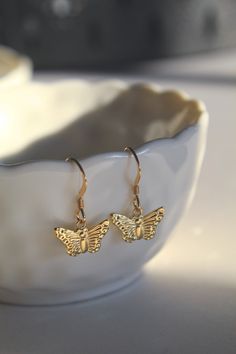 A stunning and lightweight design that effortlessly enhances your look! Whether its work or social, this pair will certainly compliment the occasion! Pair with our 14k Gold Butterfly Necklace.  - The Butterfly Charms are 9mm in diameter - Handmade and designed using 14k Gold Filled - Extremely comfortable and light weight. These Earrings will not weigh down your ears. - Will come beautifully packaged in a luxury padded jewellery box. All packaging is eco friendly. - Earrings, nose jewellery and Dainty Yellow Gold Earrings With Butterfly Charm, Dangle Hoop Earrings With Butterfly Charm As A Gift, Elegant Butterfly Earrings For Everyday, Elegant Butterfly Earrings For Everyday Wear, Delicate Gold Earrings With Butterfly Charm, Elegant Gold Earrings With Butterfly Charm, Elegant Everyday Butterfly Earrings, Yellow Gold Butterfly Jewelry With Piercing, Butterfly Charm Drop Earrings As Gift