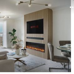 a living room filled with furniture and a flat screen tv mounted to the side of a wall